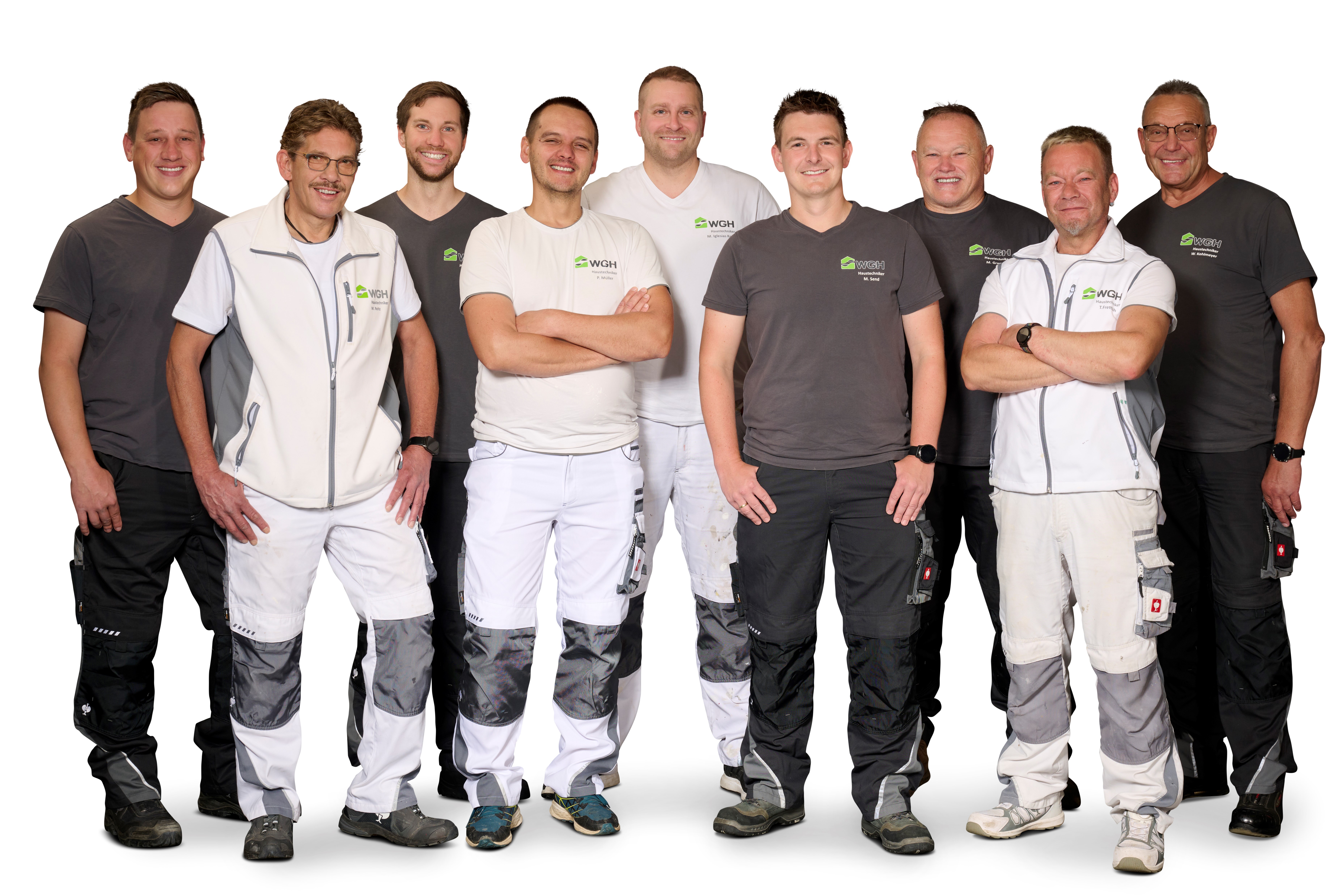 Auf dem Bild ist eine Gruppe Menschen zu sehen. Es ist das Handwerker-Team der WGH.